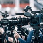 UK Shock: Prime Minister Out Broadcast cameras on tripods at a press event