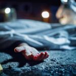 crime scene with covered body and evidence marker