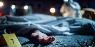 crime scene with covered body and evidence marker