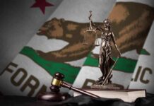 DOJ Smacked Down — California Holds Line Lady Justice statue with gavel and book before California state flag