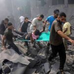 Rebuilt Mall SHATTERS — Safety Promises Exposed Rescuers carry an injured person on a stretcher through rubble