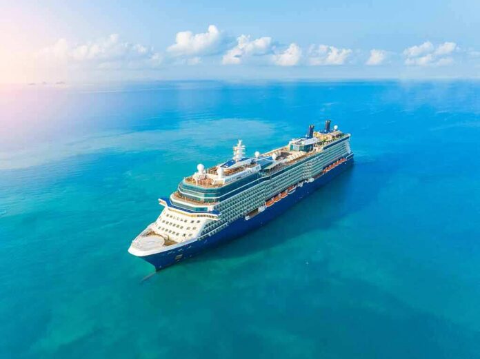 shutterstock_2450801853 Cruise ship sailing on calm turquoise sea