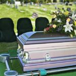 One Pill Theory Shocks Hollywood – Actress Dead casket with floral arrangement at outdoor graveside service