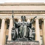 Alma Mater statue before a neoclassical library facade