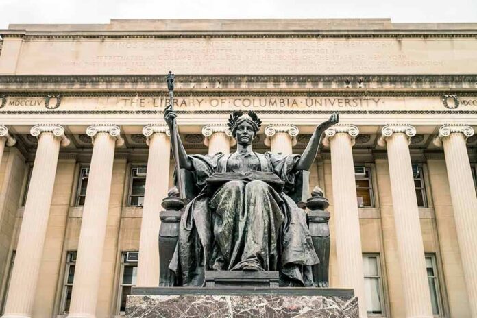 shutterstock_452410822 Alma Mater statue before a neoclassical library facade