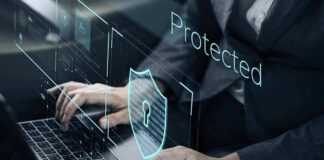 Person typing on laptop with digital security shield overlay