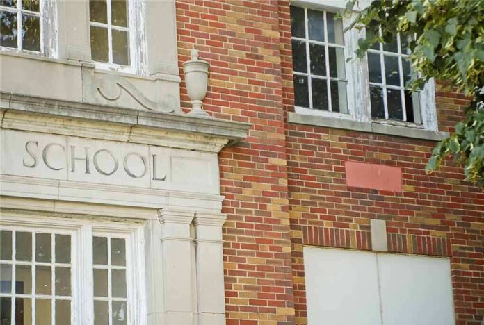 Old brick school building facade with windows and doorway