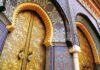 Arab World Jolt: Woman PM, Monarch Rules ornate golden doors with colorful mosaic arches