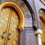ornate golden doors with colorful mosaic arches