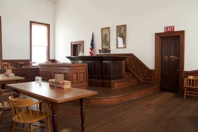 Tombstone,,Arizona,Courthouse,Courtroom Interior of a historic courtroom with wooden furniture and an American flag