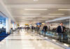 FBI Steps In After Selma Blair’s Wild Flight Airport terminal with passengers on a moving walkway