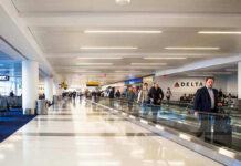 Airport terminal with passengers on a moving walkway