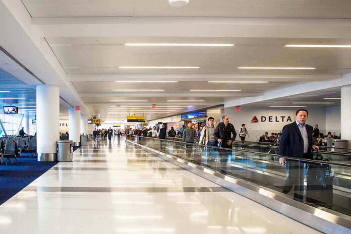 Airport terminal with passengers on a moving walkway