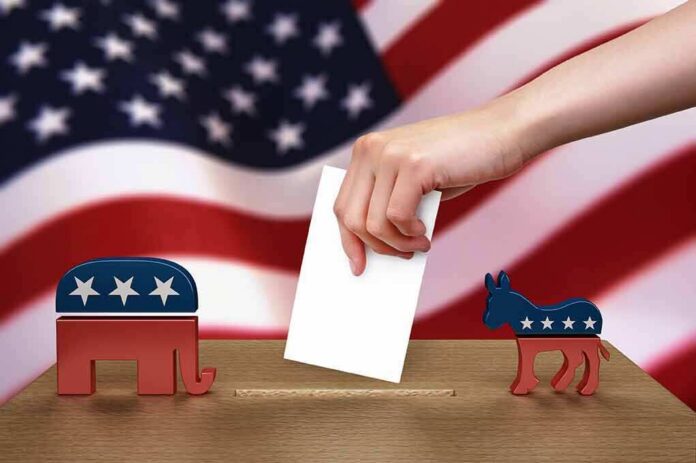 Hand casting ballot between Republican elephant and Democratic donkey