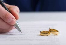 Germany’s Child-Marriage Gap Stuns Hand signing a document beside two gold wedding rings