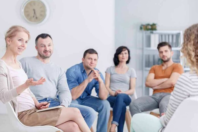 Support group meeting with six adults seated in a circle