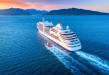 Luxury Cruise Eviction Shocks Residents Cruise ship sailing at sunset near mountainous coastline