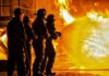 Wind-Whipped Inferno Slams Orange County Firefighters battling a large blaze with a hose