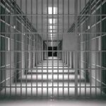 Death Chamber Chaos Exposed empty prison corridor with barred cells
