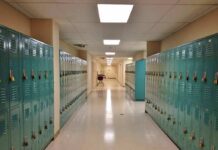 Backpack Soaked In Urine- Professor Tied To Pattern School hallway with rows of teal lockers