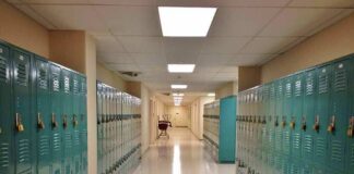 School hallway with rows of teal lockers