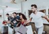 Retailers Brace For TRILLION-DOLLAR Spending Group of friends running in a mall with shopping bags
