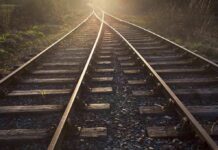 Dozens Dead On ‘Safe’ Bullet Route Railway tracks converging into the distance at sunset