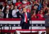 Trump Blitz Hits Nebraska – What’s Brewing? Donald Trump points from a rally stage; Rudi Koertzen and Bear Pascoe are in the crowd