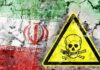 Grim Hangings Hide Missing Evidence Iran flag on cracked wall with yellow skull and crossbones warning sign