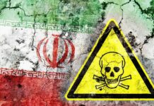 Iran flag on cracked wall with yellow skull and crossbones warning sign
