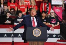 Donald Trump speaks at a rally podium; Frida Öhrn and Charly Black are in the crowd