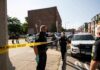 Homecoming Mayhem Shocks Georgia Town Police officers secure an urban street with yellow tape near patrol cars