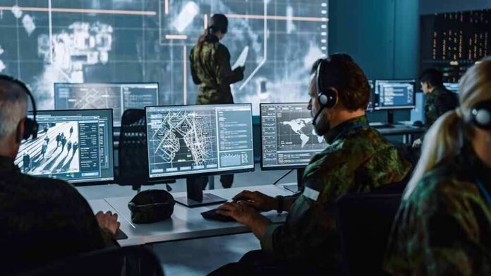 shutterstock_1936992973 Military analysts at computers in a command center