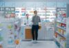 Yvonne Li assisting a customer at a pharmacy counter