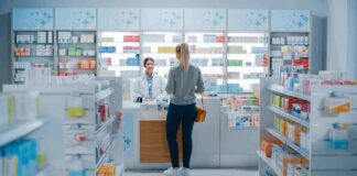 Yvonne Li assisting a customer at a pharmacy counter