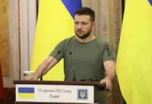 Shock Demand: New Ukraine President Now Man at a podium with Ukrainian flags