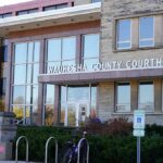 Impostor Teacher Terrorizes Milwaukee Classrooms Waukesha County Courthouse entrance with glass facade and signage
