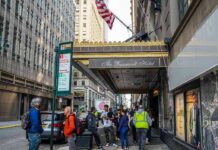 Hate Crime Fear Grips Midtown Andreas Hestler and pedestrians outside The Roosevelt Hotel entrance on a city sidewalk