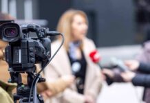 ‘We Have Guns Too’ Explodes Online Video camera filming an outdoor media interview