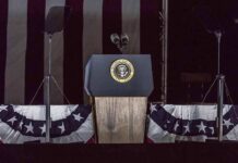 Presidential podium with microphones and teleprompters